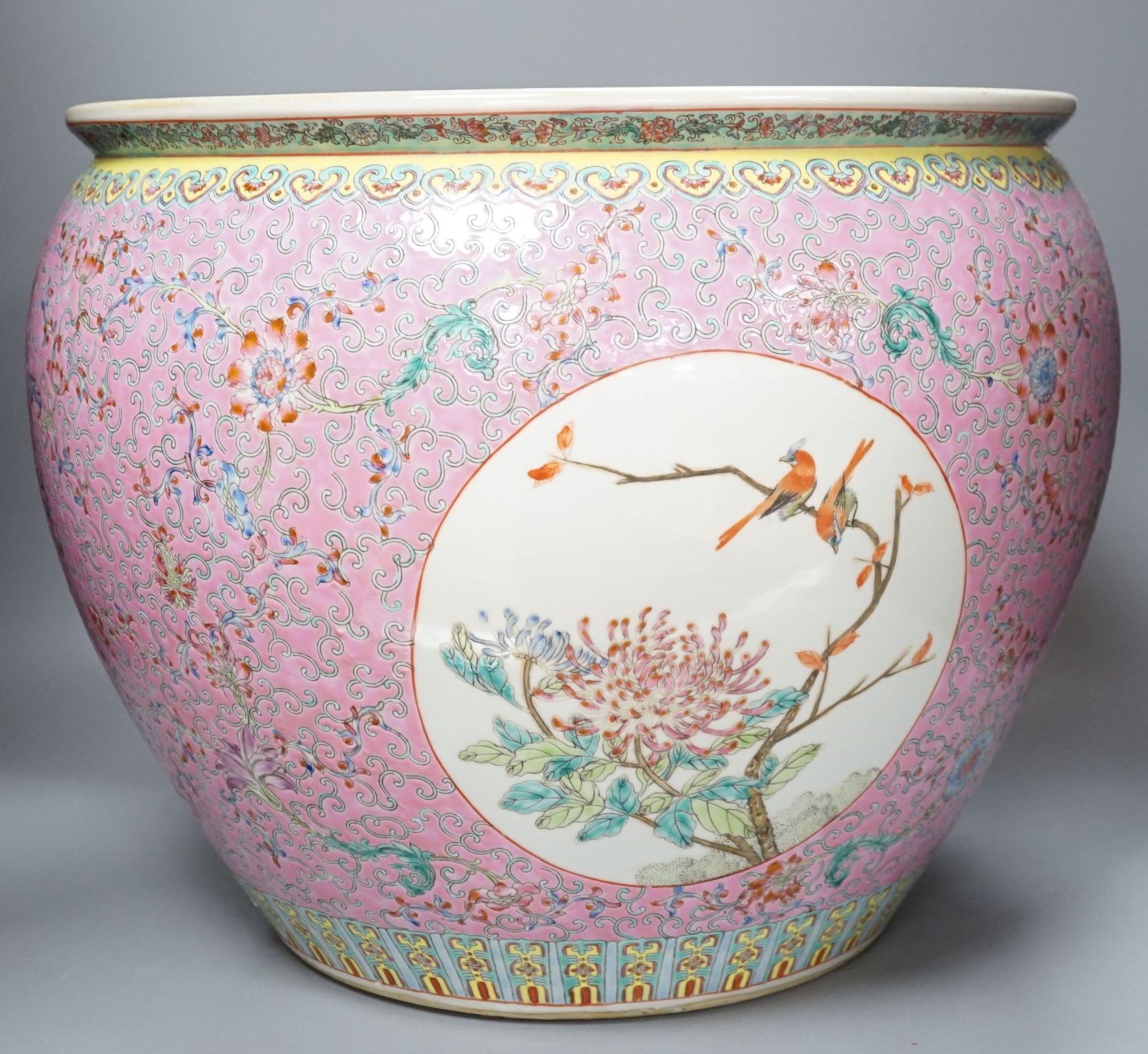 A Chinese famille rose fish bowl, 36 cms high.